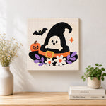 Finished ghost in witch hat artwork displayed on a wall
