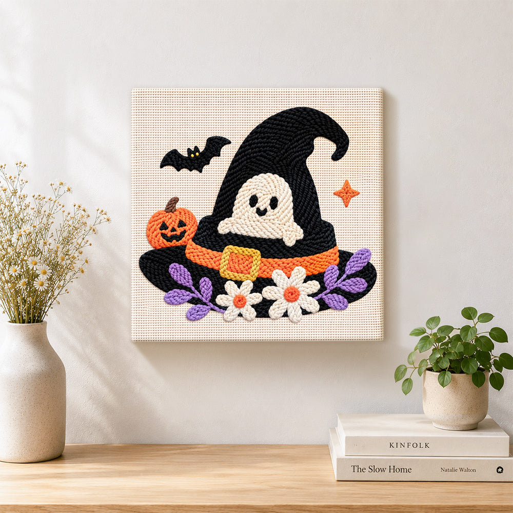 Finished ghost in witch hat artwork displayed on a wall