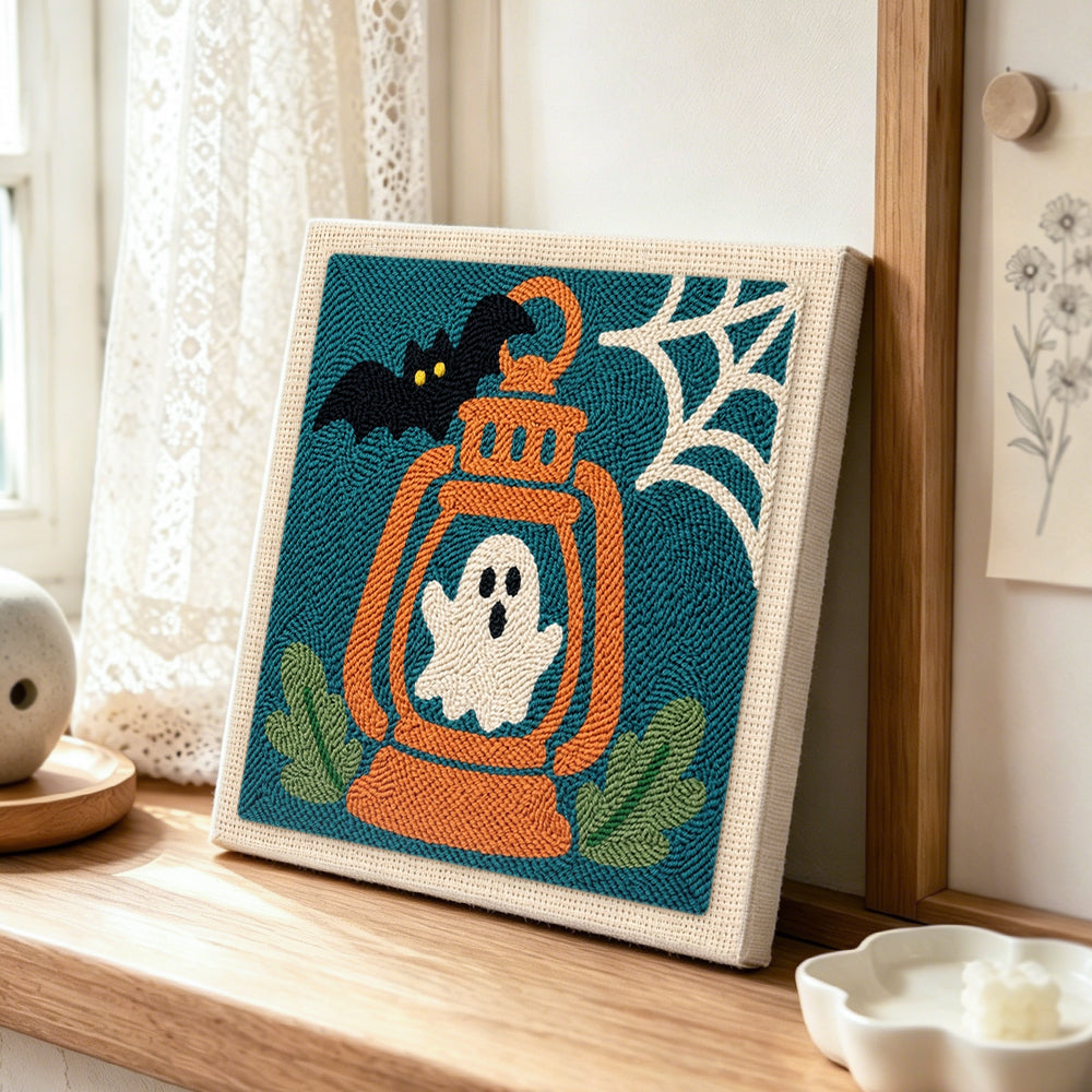 Ghost inside lantern punch needle artwork displayed on a table