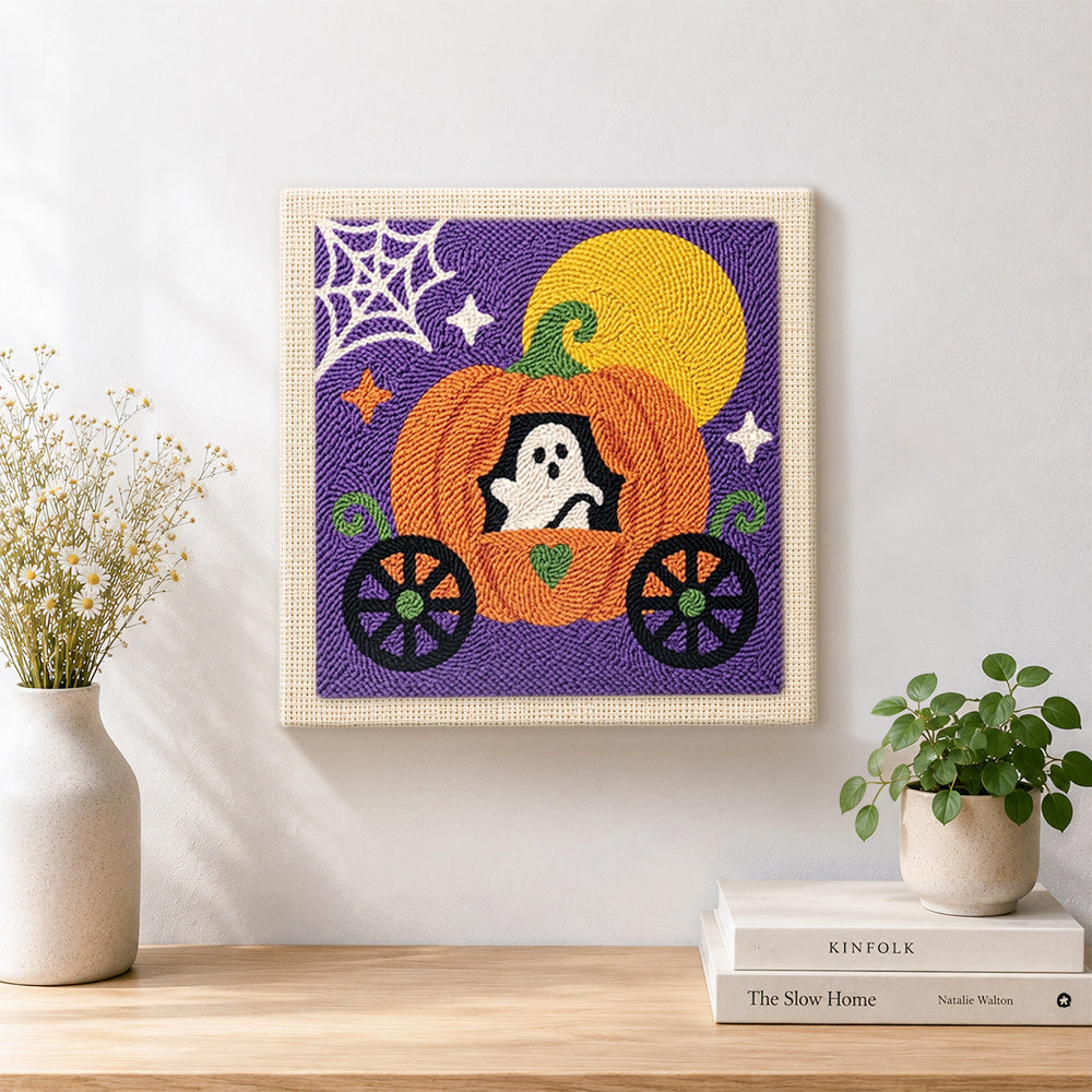 Finished ghost inside pumpkin carriage artwork displayed on a wall