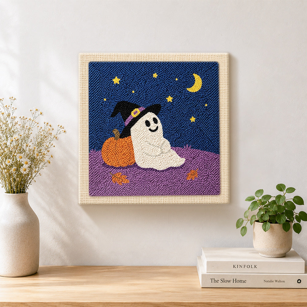 Finished ghost leaning on pumpkin artwork displayed on a wall