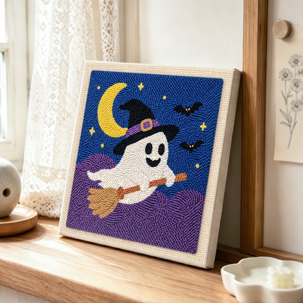Ghost on broomstick punch needle artwork displayed on a table