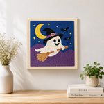 Finished ghost on broomstick artwork displayed on a wall