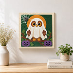 Finished ghost‑owl with pumpkins artwork displayed on a wall