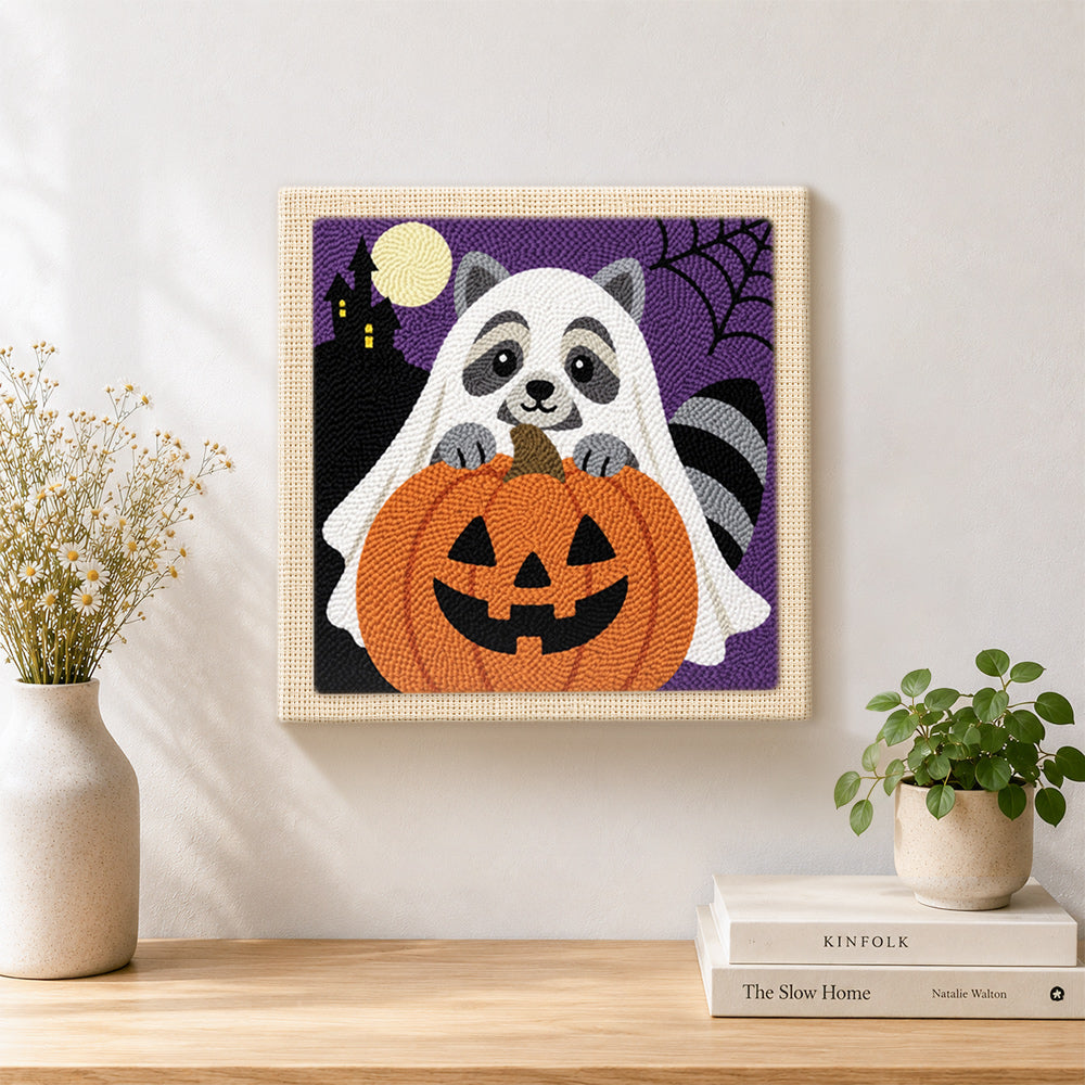 Finished ghost raccoon and pumpkin artwork displayed on a wall