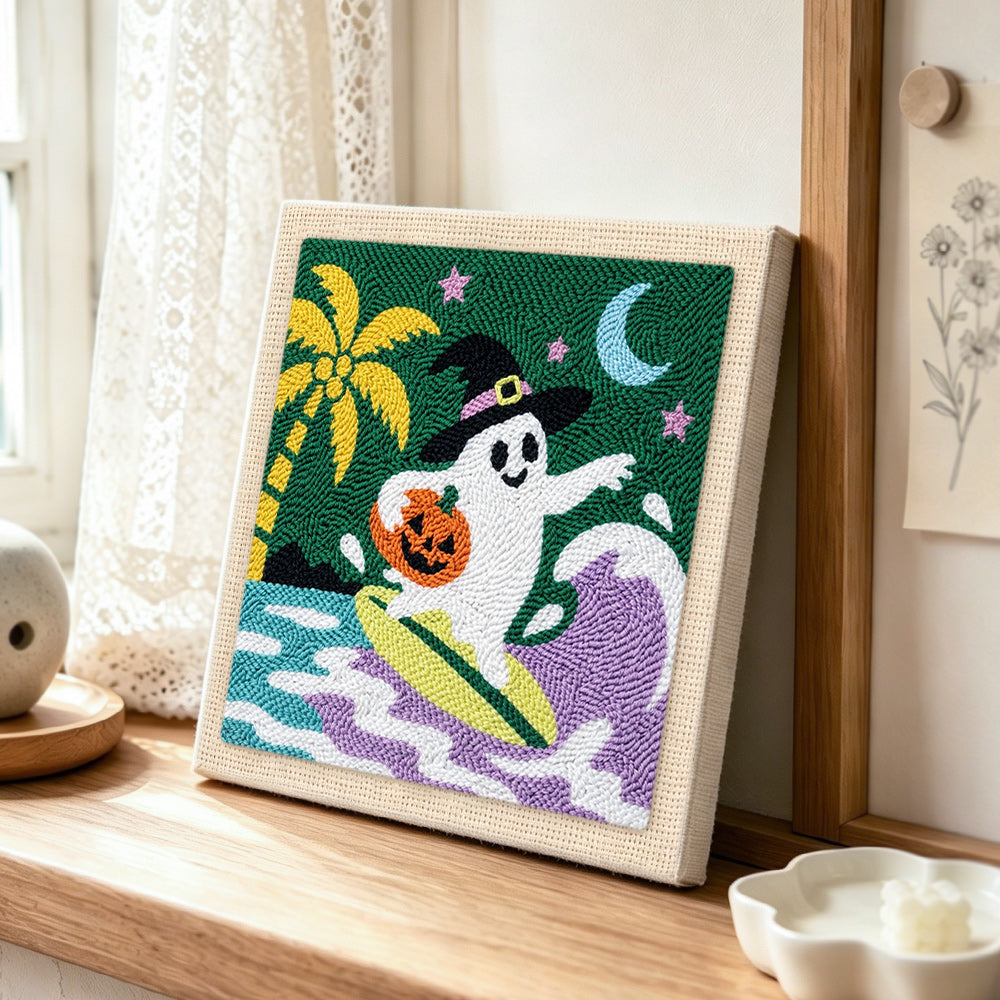 Ghost surfing on waves punch needle artwork displayed on a table