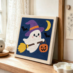 Ghost witch on broom punch needle artwork displayed on a table