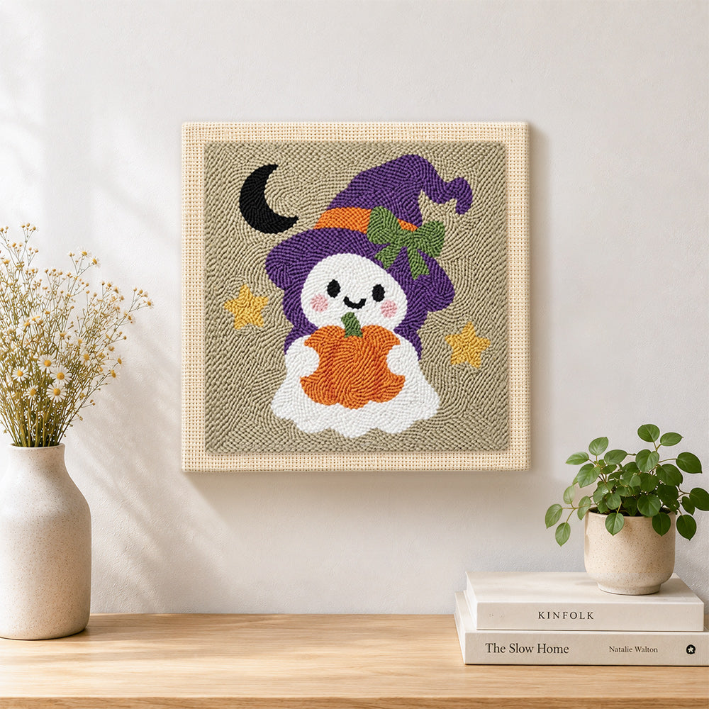 Finished ghost witch with pumpkin lantern artwork displayed on a wall