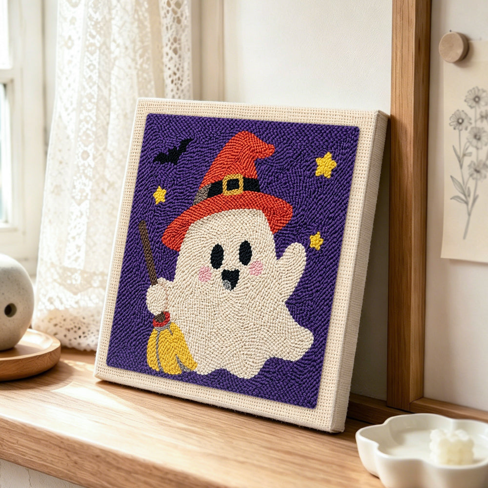 Ghost with broom punch needle artwork displayed on a table