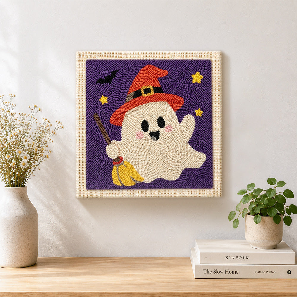 Finished ghost with broom artwork displayed on a wall