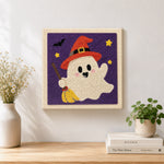 Finished ghost with broom artwork displayed on a wall