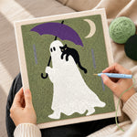 Creating handmade ghost with purple umbrella punch needle artwork