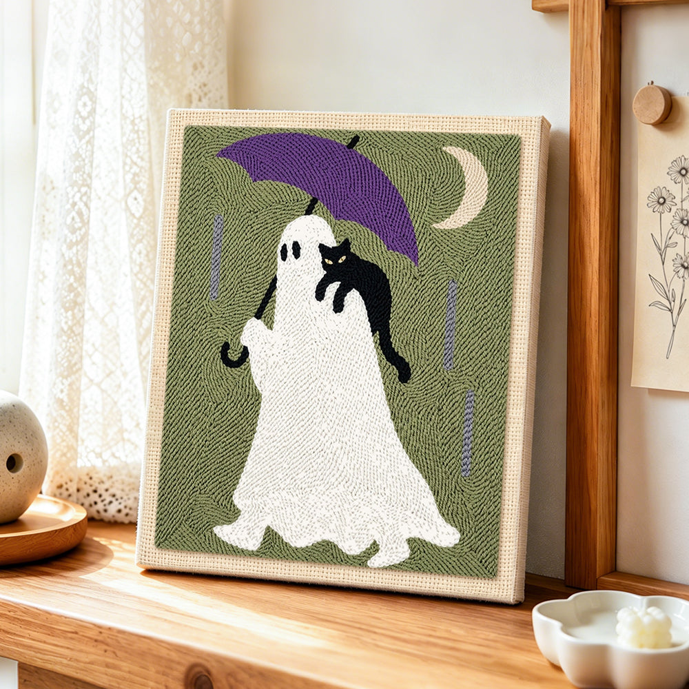 Ghost with purple umbrella punch needle artwork displayed on a table