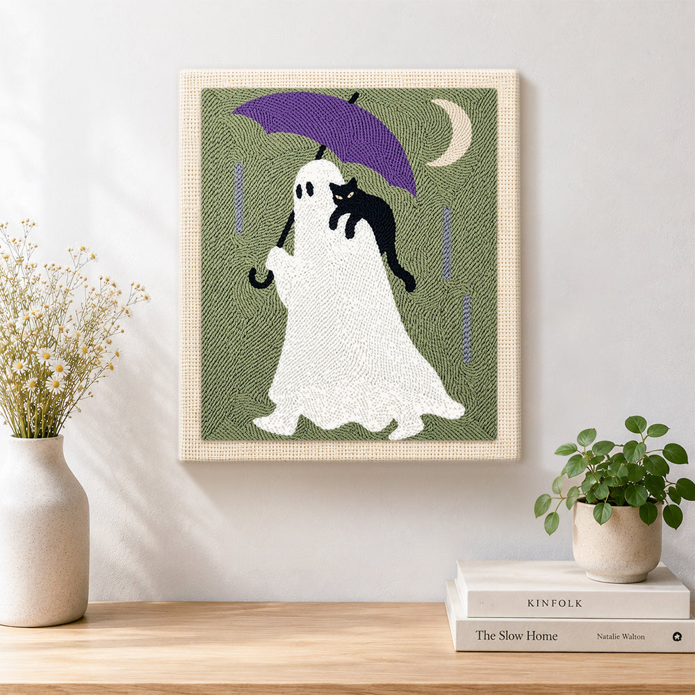 Finished ghost with purple umbrella artwork displayed on a wall