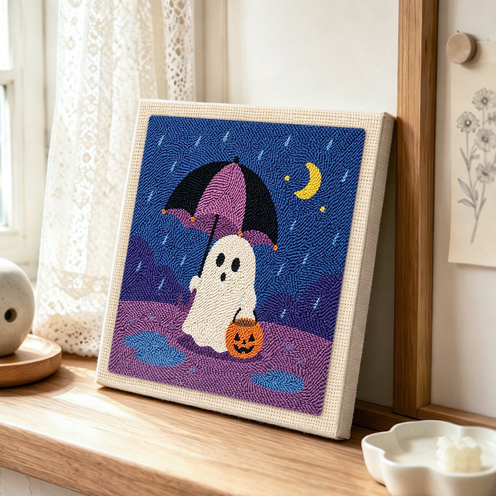 Ghost with rain umbrella punch needle artwork displayed on a table