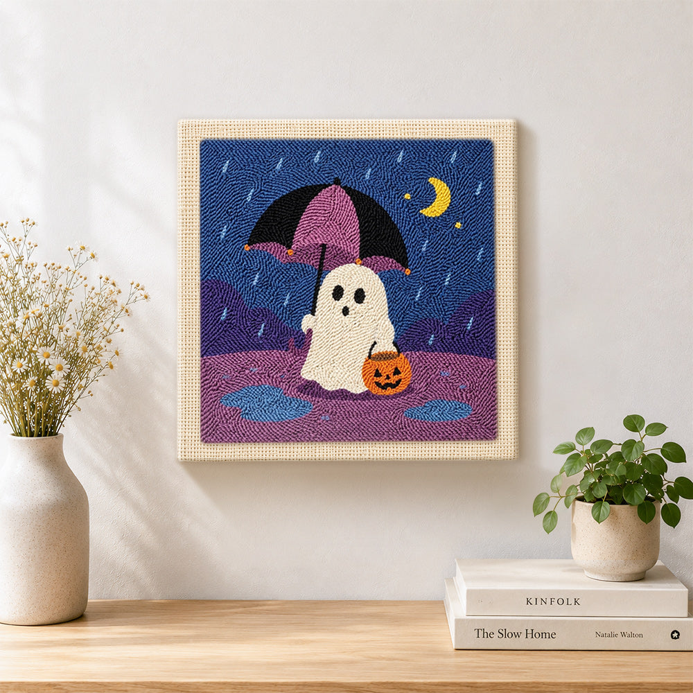 Finished ghost with rain umbrella artwork displayed on a wall