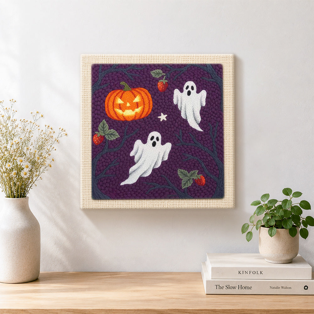 Finished ghosts and wild pumpkin artwork displayed on a wall