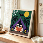 Ghosts camping reading punch needle artwork displayed on a table
