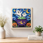 Finished ghosts in magic cauldron artwork displayed on a wall