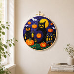 Giant black cat and spooky halloween pumpkins needle felt wall art displayed in a bright home interior