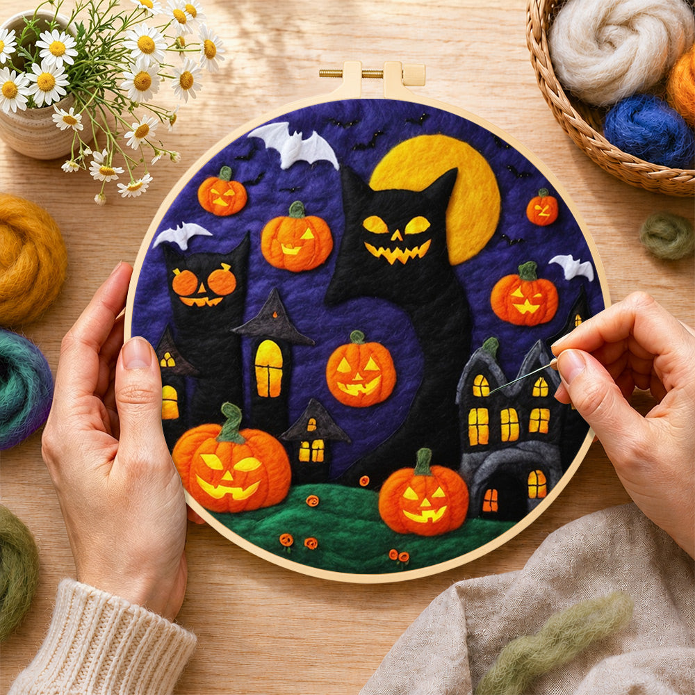Creating the giant black cat and spooky halloween pumpkins wool painting by hand with a felting needle