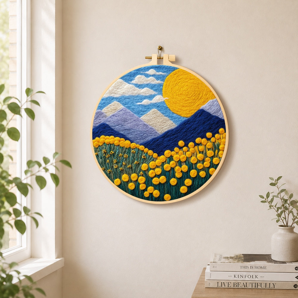Giant sun, mountains and yellow flowers needle felt wall art displayed in a bright home interior