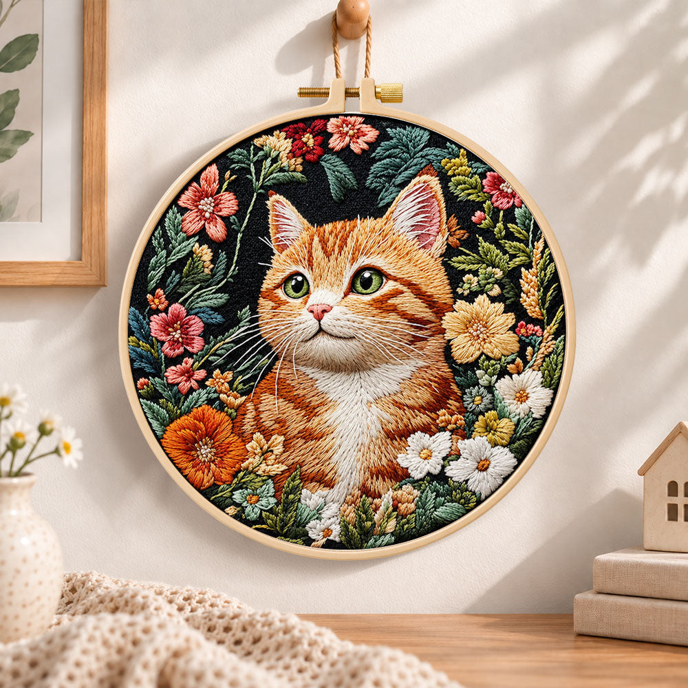 Ginger cat in wild blooms embroidery hoop wall art displayed as warm and cozy handmade home decor