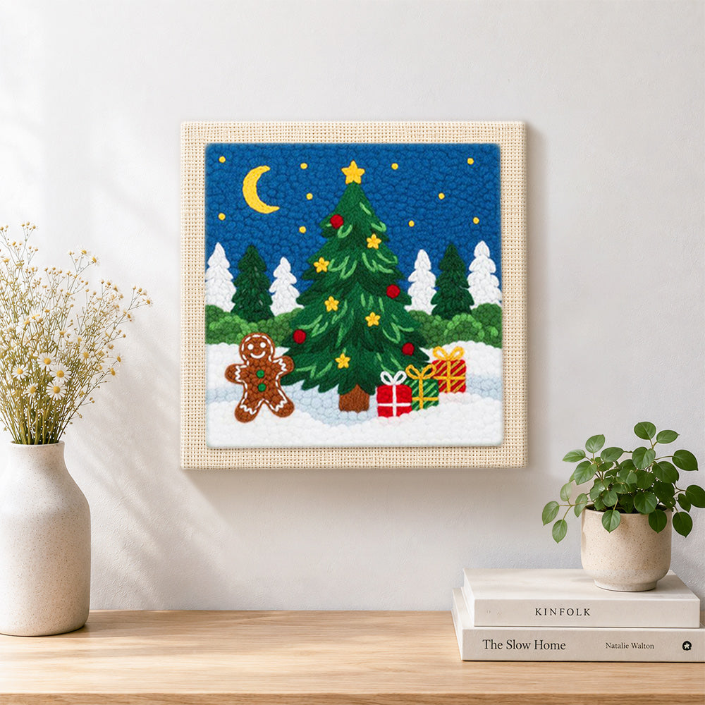 Finished gingerbread man and christmas tree artwork displayed on a wall