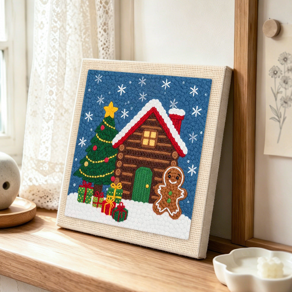 Gingerbread man cabin punch needle artwork displayed on a table