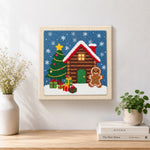 Finished gingerbread man cabin artwork displayed on a wall
