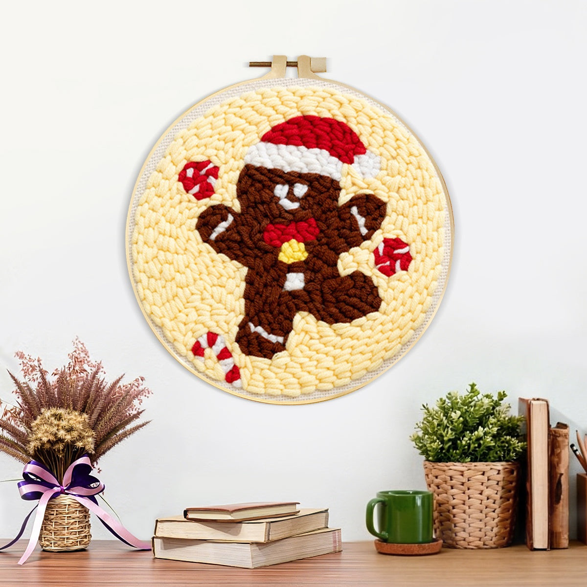 Finished gingerbread man with santa hat artwork displayed on a wall