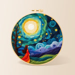 Girl in red dress under swirling starry night needle felting kit for beginners with a round wooden frame