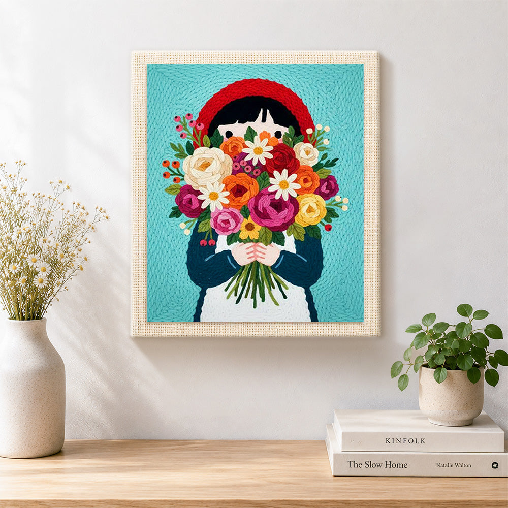 Finished girl in red headscarf holding flowers artwork displayed on a wall