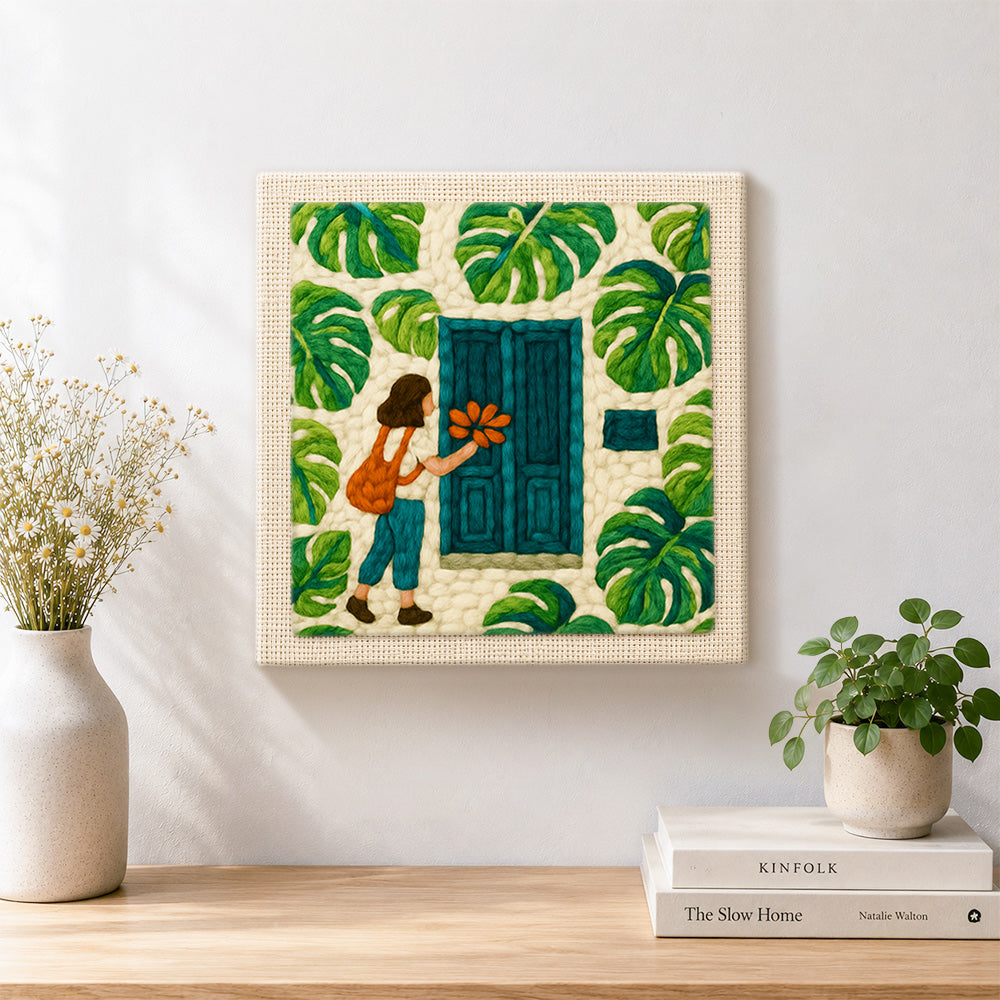 Finished girl, teal door and monstera leaves artwork displayed on a wall