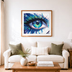 Finished glimmering aqua gaze cross stitch artwork displayed as home decor