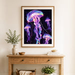 Finished glowing neon jellyfish cross stitch artwork displayed as home decor