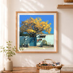 Finished golden autumn courtyard cross stitch artwork displayed as home decor