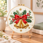 Golden christmas bells embroidery kit finished hoop displayed on a wooden stand as cozy tabletop decor
