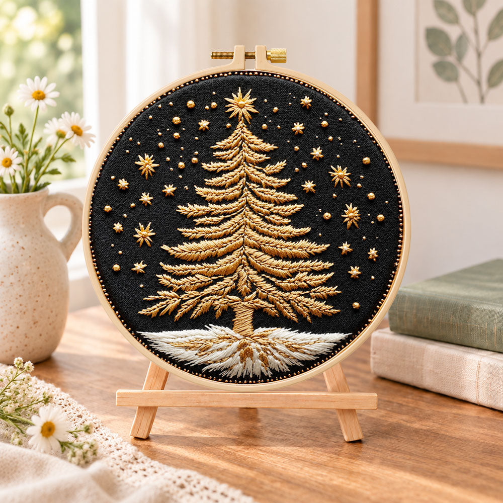 Golden festive tree embroidery kit finished hoop displayed on a wooden stand as cozy tabletop decor