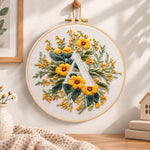Golden florals and letter a embroidery hoop wall art displayed as warm and cozy handmade home decor