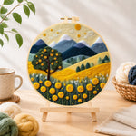 Finished golden harvest tree and mountains needle felting displayed on a wooden easel