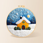 Golden snowy house under starry sky needle felting kit for beginners with a round wooden frame