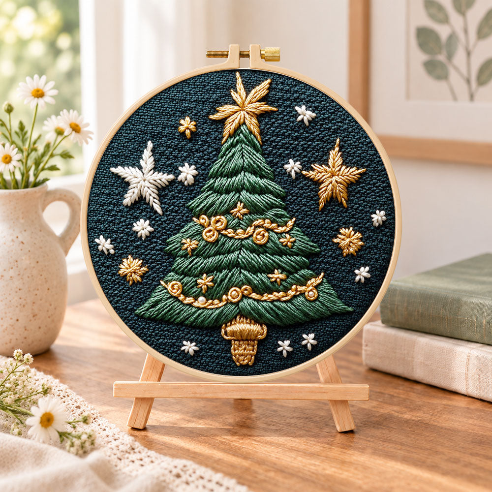 Golden star christmas tree embroidery kit finished hoop displayed on a wooden stand as cozy tabletop decor