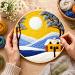 Creating the golden sun and blue mountain snowscape wool painting by hand with a felting needle