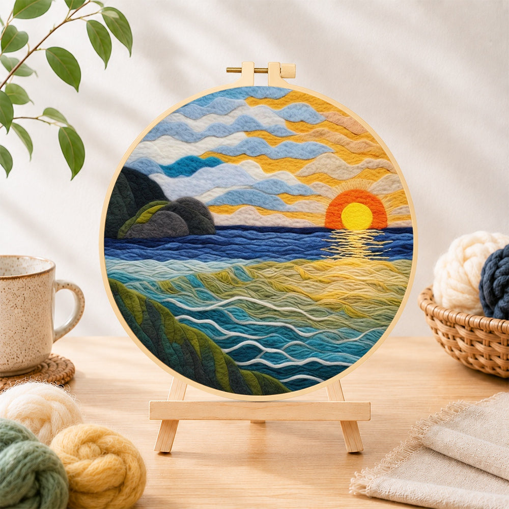 Finished golden sunset and textured rolling waves needle felting displayed on a wooden easel