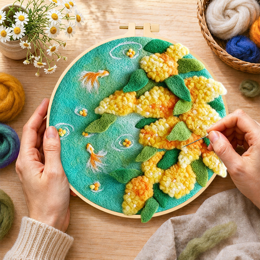 Creating the goldfish with yellow plants wool painting by hand with a felting needle