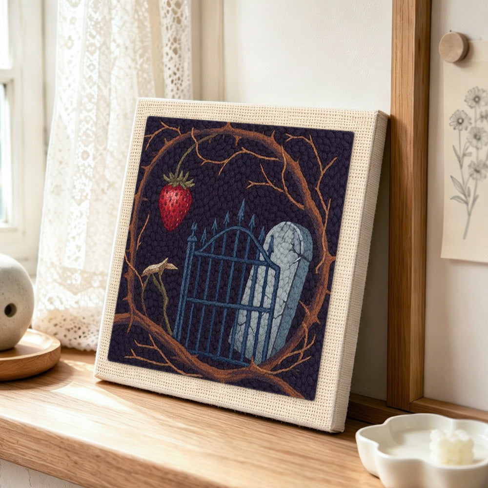 Gothic graveyard scene punch needle artwork displayed on a table