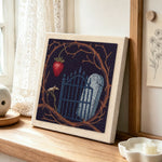 Gothic graveyard scene punch needle artwork displayed on a table