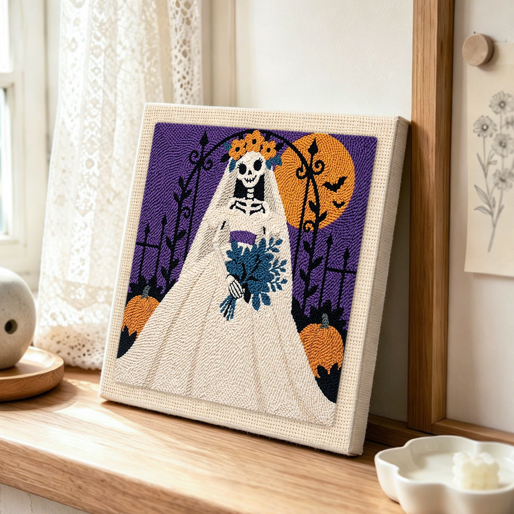 Gothic skeleton bride punch needle artwork displayed on a table