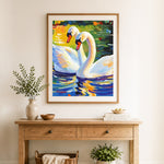 Finished graceful white swans cross stitch artwork displayed as home decor